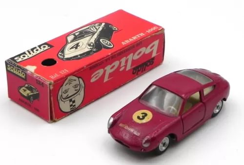 Red Abarth 1000 diecast sports car with black decals, in original box