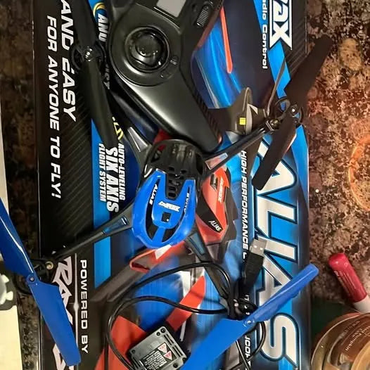 Blue and black quad rotor drone with propellers and landing gear, close-up