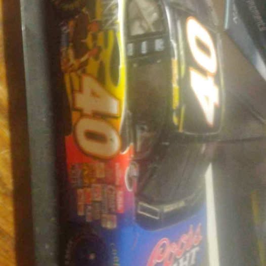 Diecast model car with colorful side graphics and wheels visible