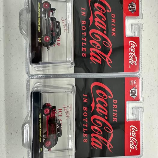 Diecast race car set, two boxed cars in red and black with Drinker logo