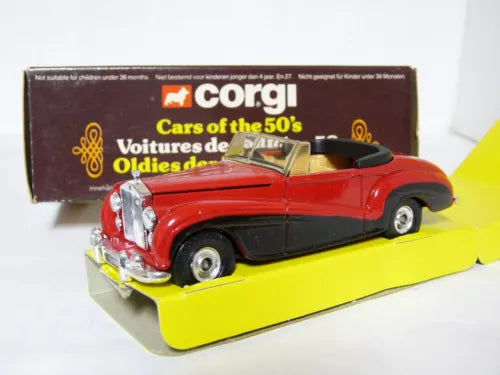 Diecast model car toy of a red vintage coupe with black detailing and silver grille