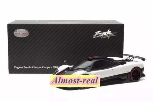White and black diecast model coupe with red wheel accents, Pagani Zonda Cinque 2009