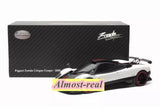 White and black diecast model coupe with red wheel accents, Pagani Zonda Cinque 2009