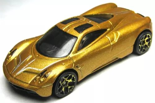 Gold die-cast sports car with black stripe and spoiler detail, 1:64 scale
