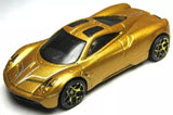 Gold die-cast sports car with black stripe and spoiler detail, 1:64 scale