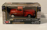 Red 1:43 die-cast 1955 Chevy stepside pickup truck model in retail box