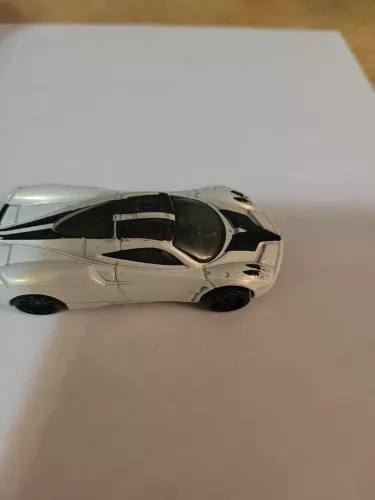 Pearl white diecast toy sports car with black windows and wheels