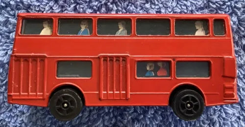 Red diecast London bus toy with black wheels and detailed windows