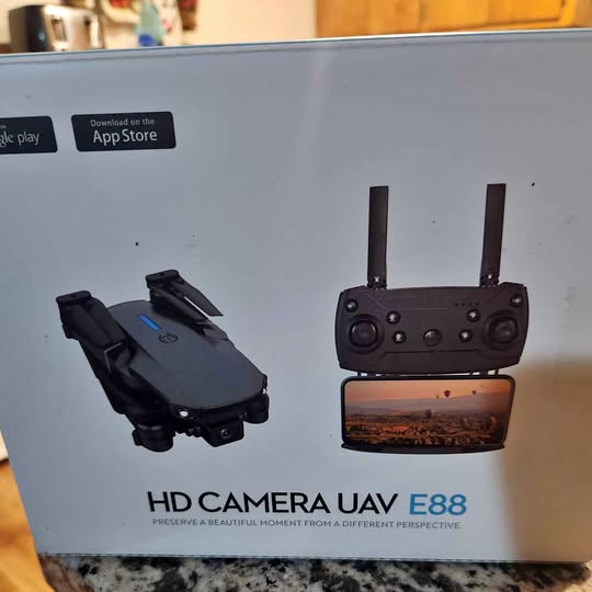 Black drone with remote controller and screen display on retail box