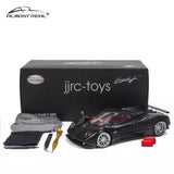 Black diecast model car with accessories, in a display box.