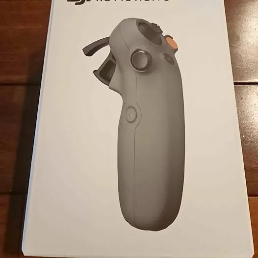 Gray motion drone controller with circular thumb sensor and side buttons