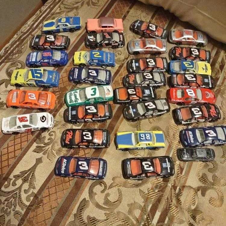 1/64 diecast race car set with multiple numbered cars on display