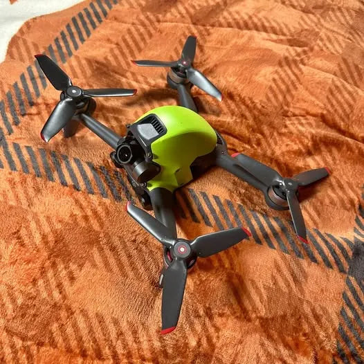DJI FPV drone with lime-green body and four black propeller arms
