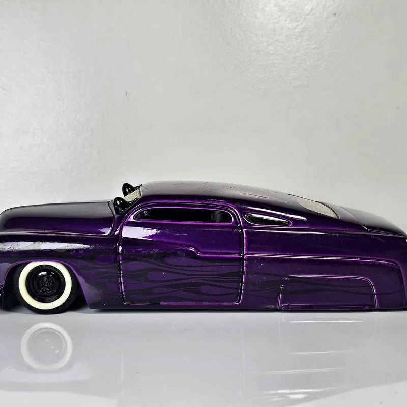 Purple 1951 Mercury diecast car, front-side view with whitewall tires