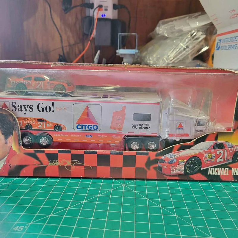 1:64 Nascar hauler diecast truck, orange and black checkered with car graphic, 21