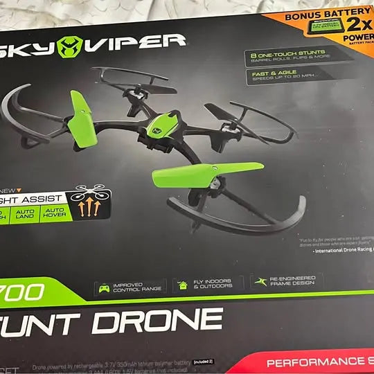 Green and black quadcopter stunt drone with four propellers