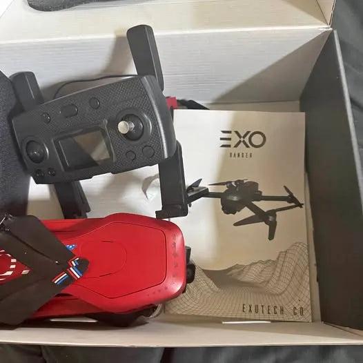 Red drone and handheld controller with antennas in open packaging
