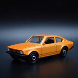 Orange 1970s coupe diecast model car with black grille and wheels
