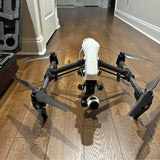 DJI Inspire 1 V2 drone with white body and four black propeller arms