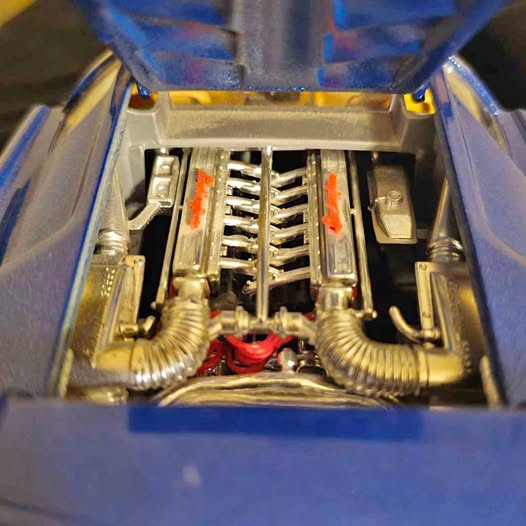 1/18 diecast car engine bay with chrome components and blue body