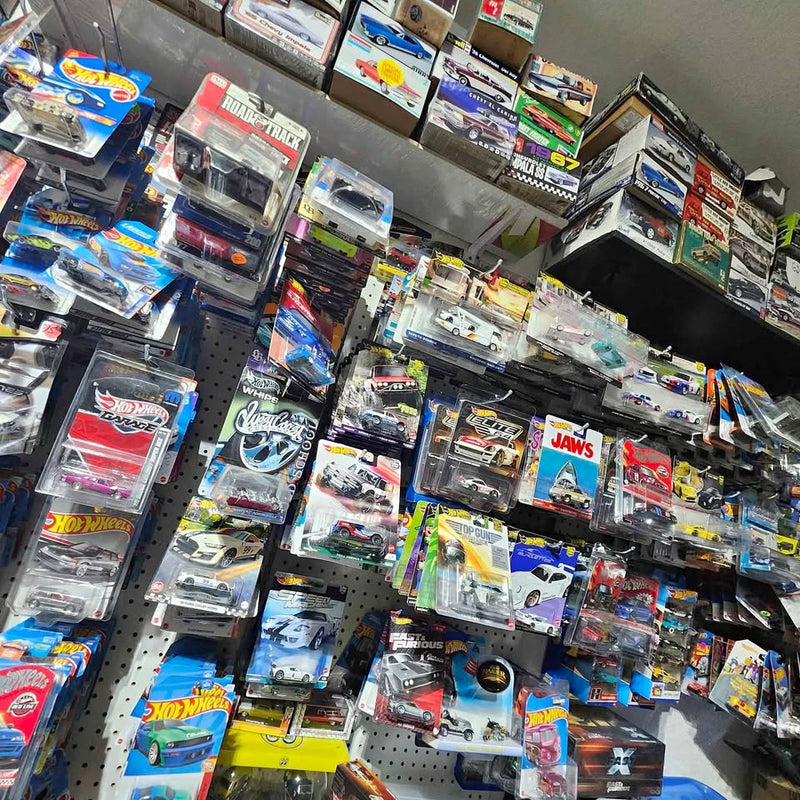 Diecast model car assortment in clear blister packs with colorful branding