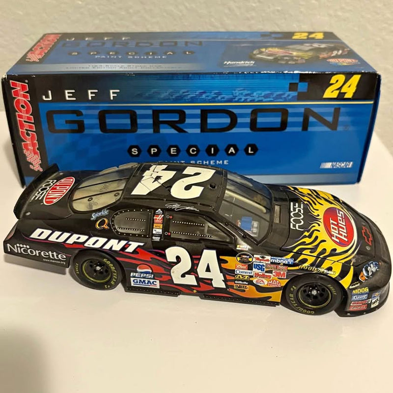 NASCAR diecast race car, #24 design in black, red, and white; in blue box