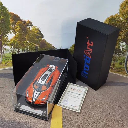 Resin diecast car model in clear display case with certificate and black presentation box