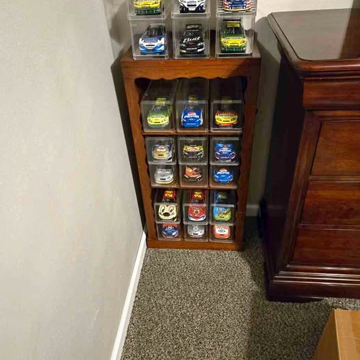 Ford City diecast car display with multiple miniature cars in wooden slots