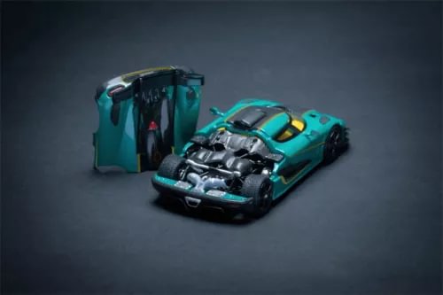 Turquoise diecast sports car model with hood open and engine visible