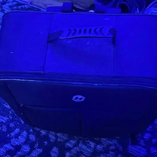Drone underside with central logo and landing leg, dark housing