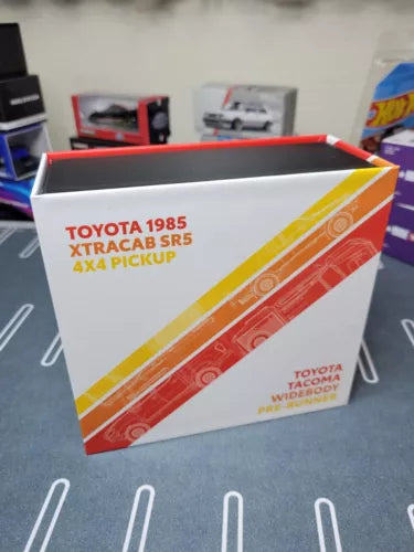 Diecast model car box for Toyota trucks, red and white packaging with logos