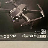 Gray foldable quadcopter drone with four propellers on the box