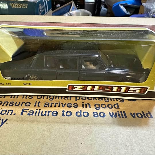 Diecast ZIL 115 limousine model in clear window box, dark green/black