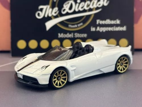 White diecast roadster car with gold wheels and black windshield
