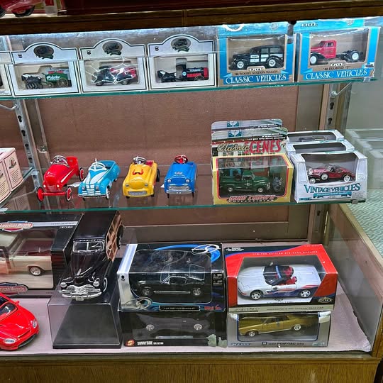 Diecast model car boxes with Hot Wheels-style vehicles, assorted colors and designs