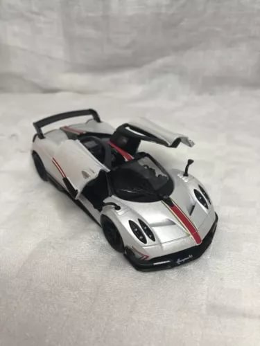 1:38 diecast model sports car in pearl white with black hood and red detailing