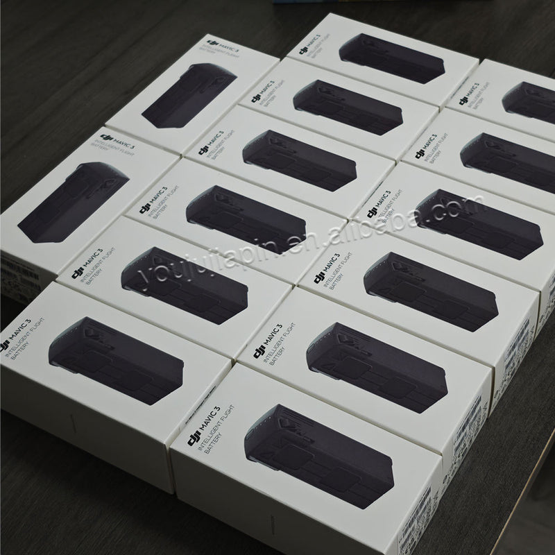 Set of boxed DJI 15.4V intelligent flight batteries with black battery window label