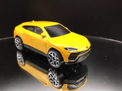 Yellow diecast SUV model car, front 3/4 view with black wheels