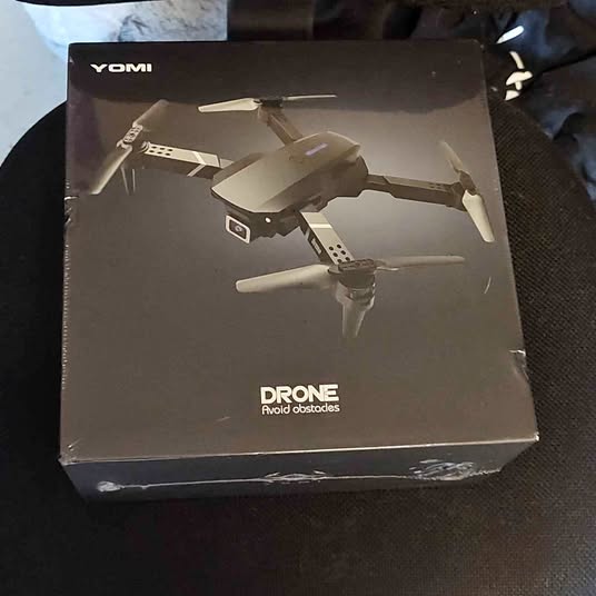 YOMI drone box with illustrated obstacle-avoidance quadcopter
