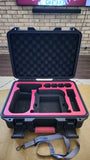 Hard drone case with open lid and molded foam interior, pink lining and carry handle