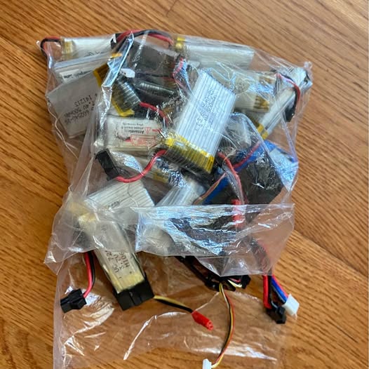 Toy drone battery assortment in plastic bag, with exposed wiring connectors