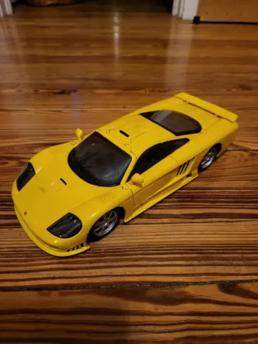 Yellow sports car diecast model (1:18) with black hood and side intakes