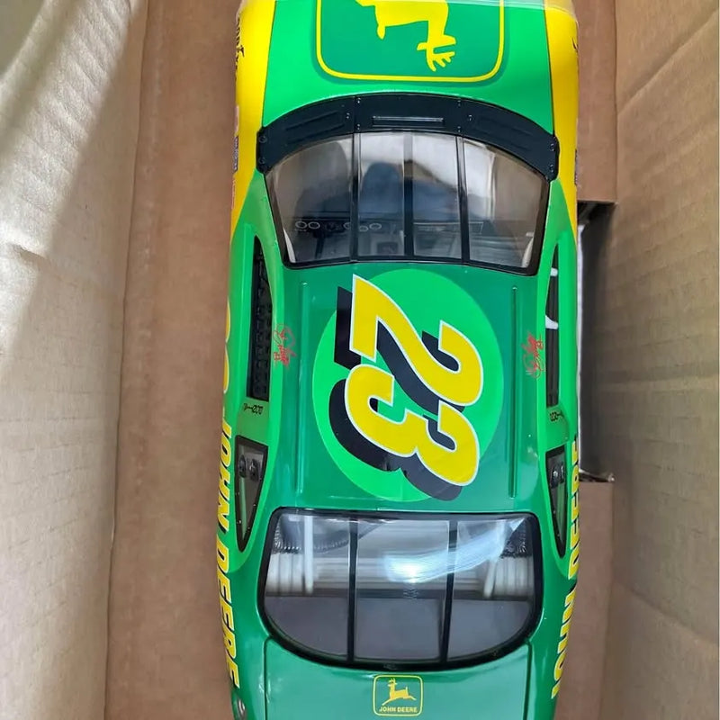 Diecast stock car front view, green body with yellow decals and grille details