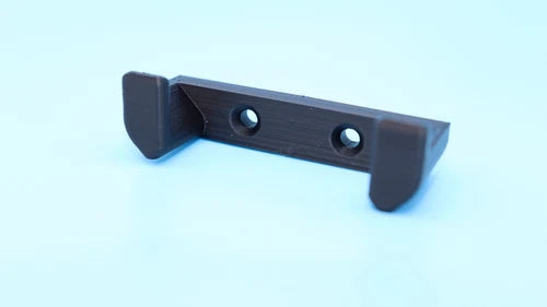 Dark FPV drone wall mount bracket with two mounting holes and side grips