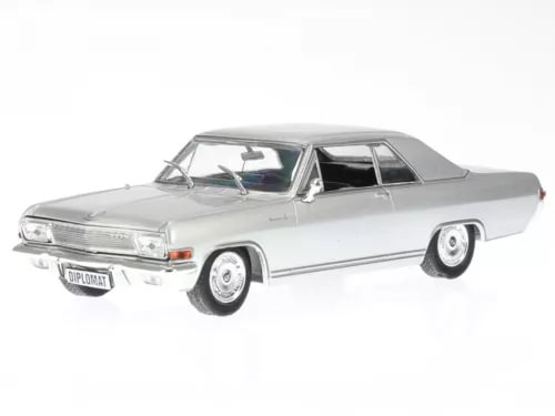 Silver diecast coupe model car with detailed chrome trim and whitewall tires