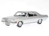 Silver diecast coupe model car with detailed chrome trim and whitewall tires