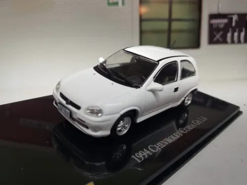 White 1:43 diecast model car, front three-quarter view on display base.