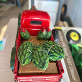 Red diecast pickup with Christmas tree decorations