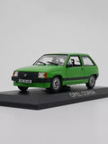 Green Opel Corsa diecast car model on display base, metal toy vehicle