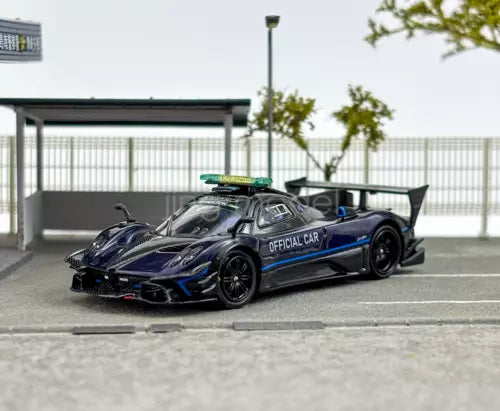 Diecast model sports car, dark blue with blue stripe and rear wing, official car